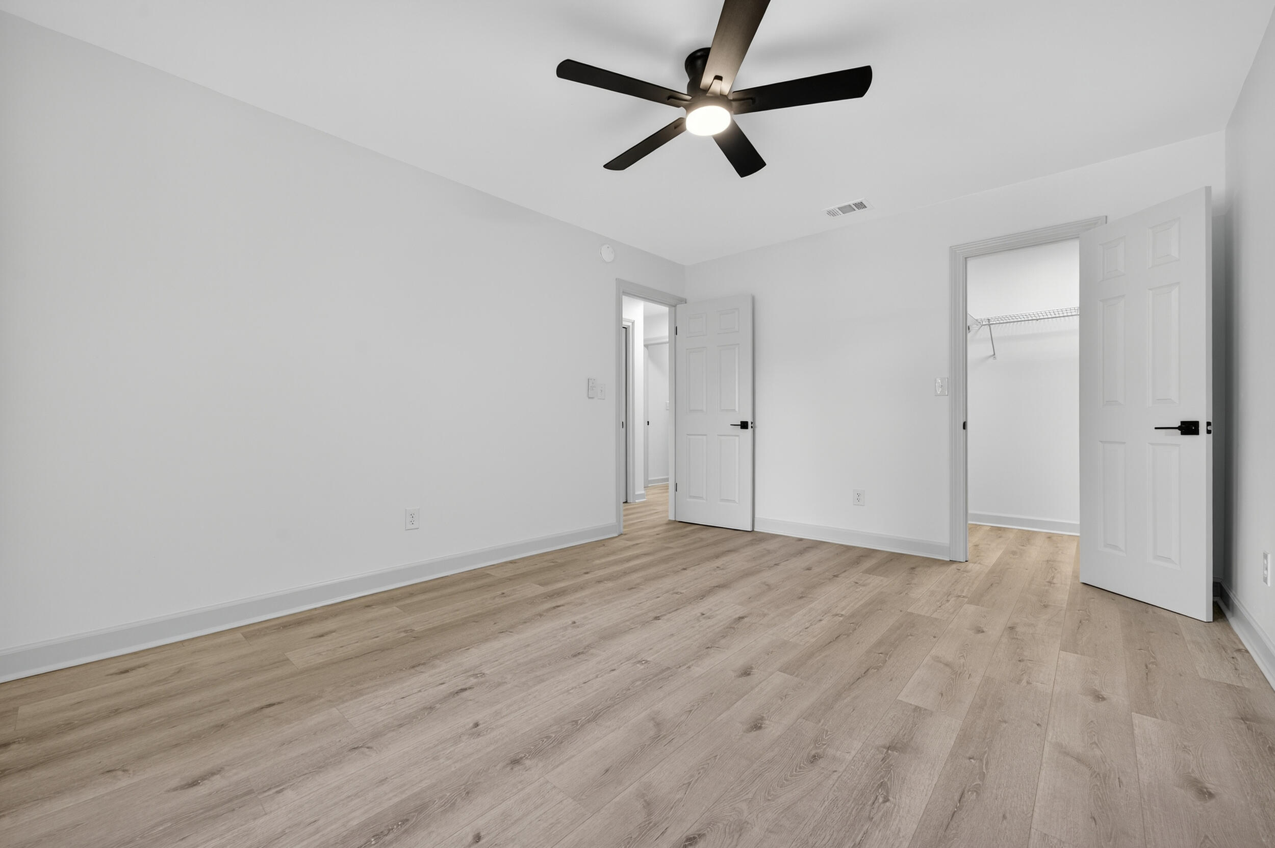 926 Ridgewood Way Niceville, FL 32578 - Photo 38 of 68 an empty room with wooden floor and windows