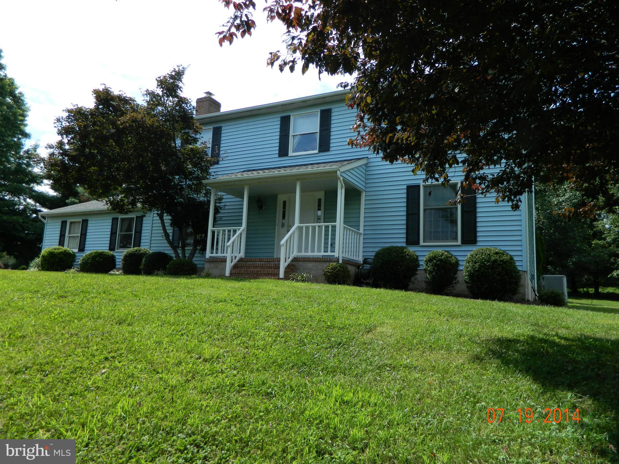 14015 Foxland Road Phoenix, MD 21131 - Photo 1 of 24 a front view of a house with a yard and trees