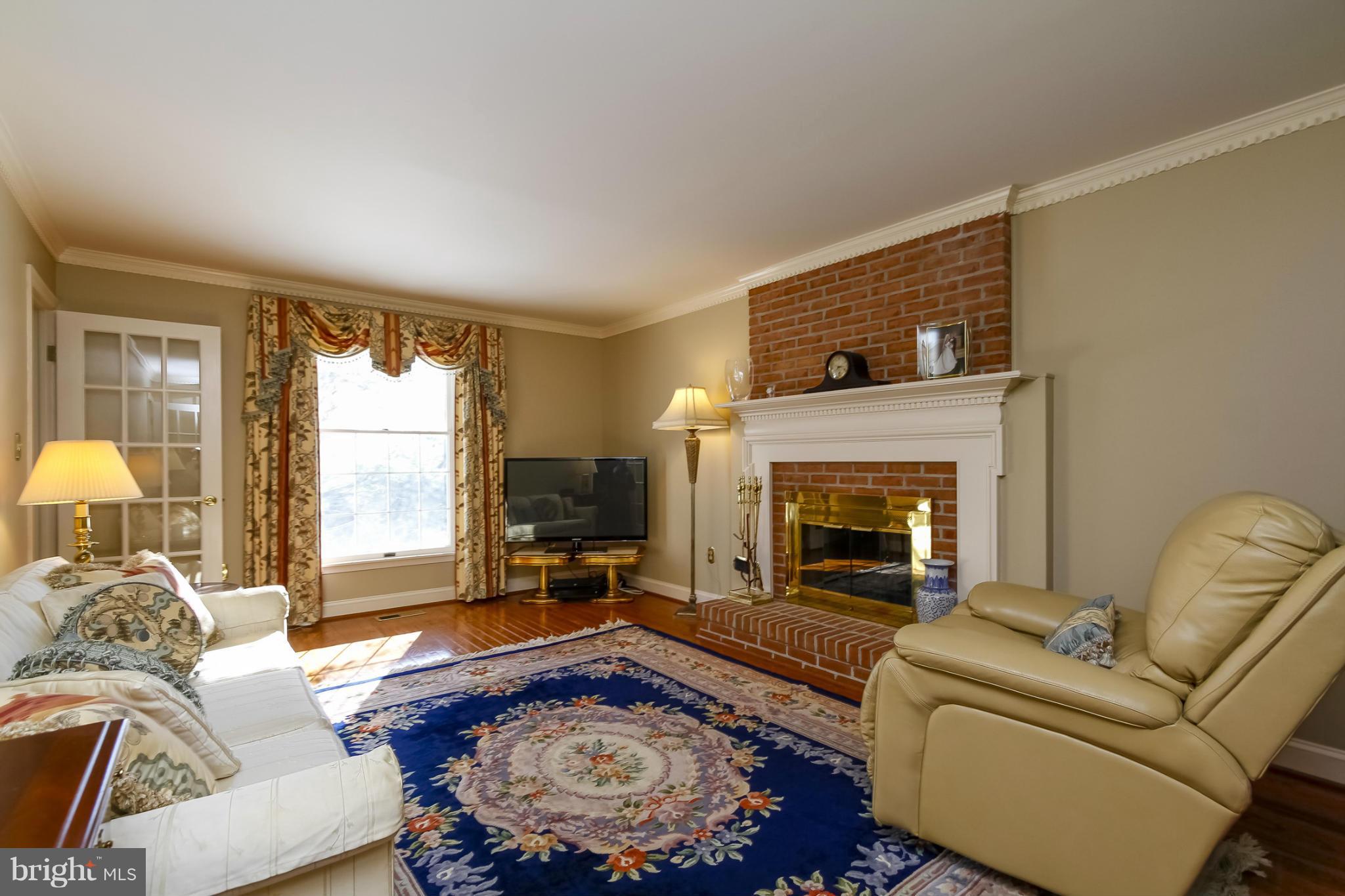 14015 Foxland Road Phoenix, MD 21131 - Photo 2 of 24 a living room with furniture and a fireplace