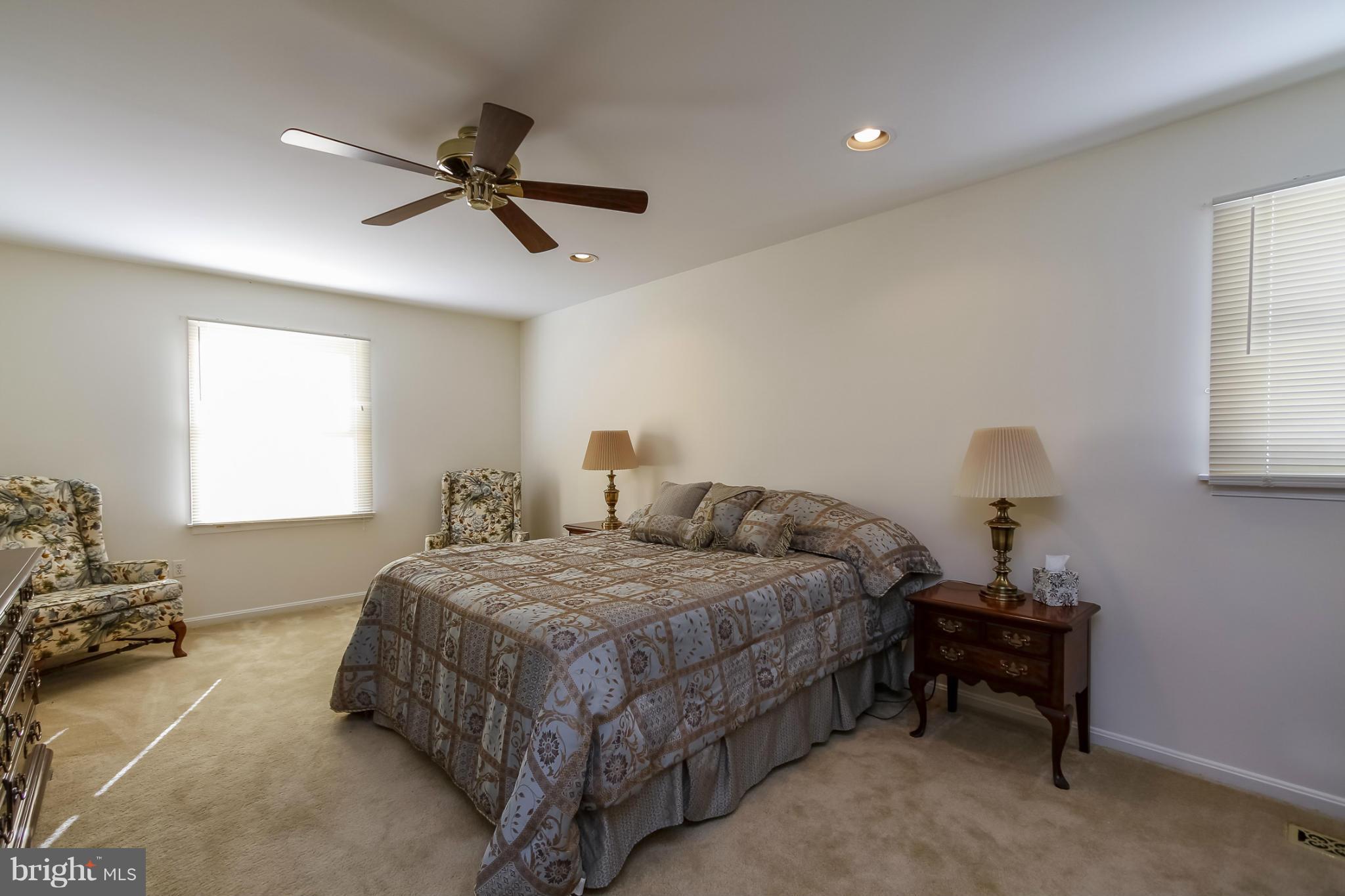 14015 Foxland Road Phoenix, MD 21131 - Photo 12 of 24 a bedroom with a bed and a chandelier