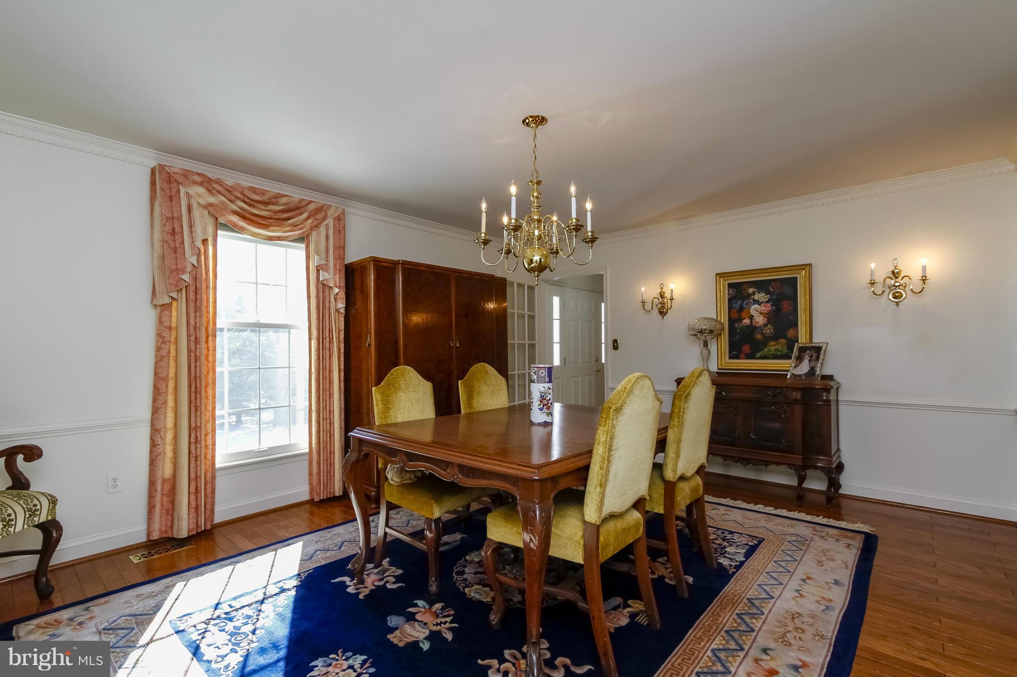 14015 Foxland Road Phoenix, MD 21131 - Photo 4 of 24 a dining room with furniture a rug and wooden floor