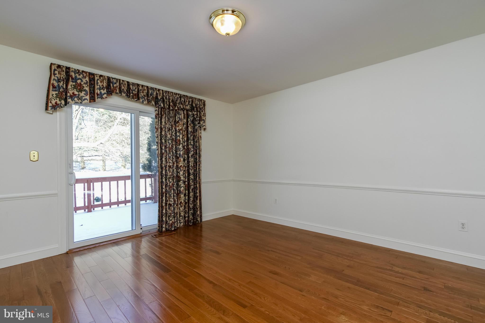 14015 Foxland Road Phoenix, MD 21131 - Photo 5 of 24 wooden floor in an empty room with a window