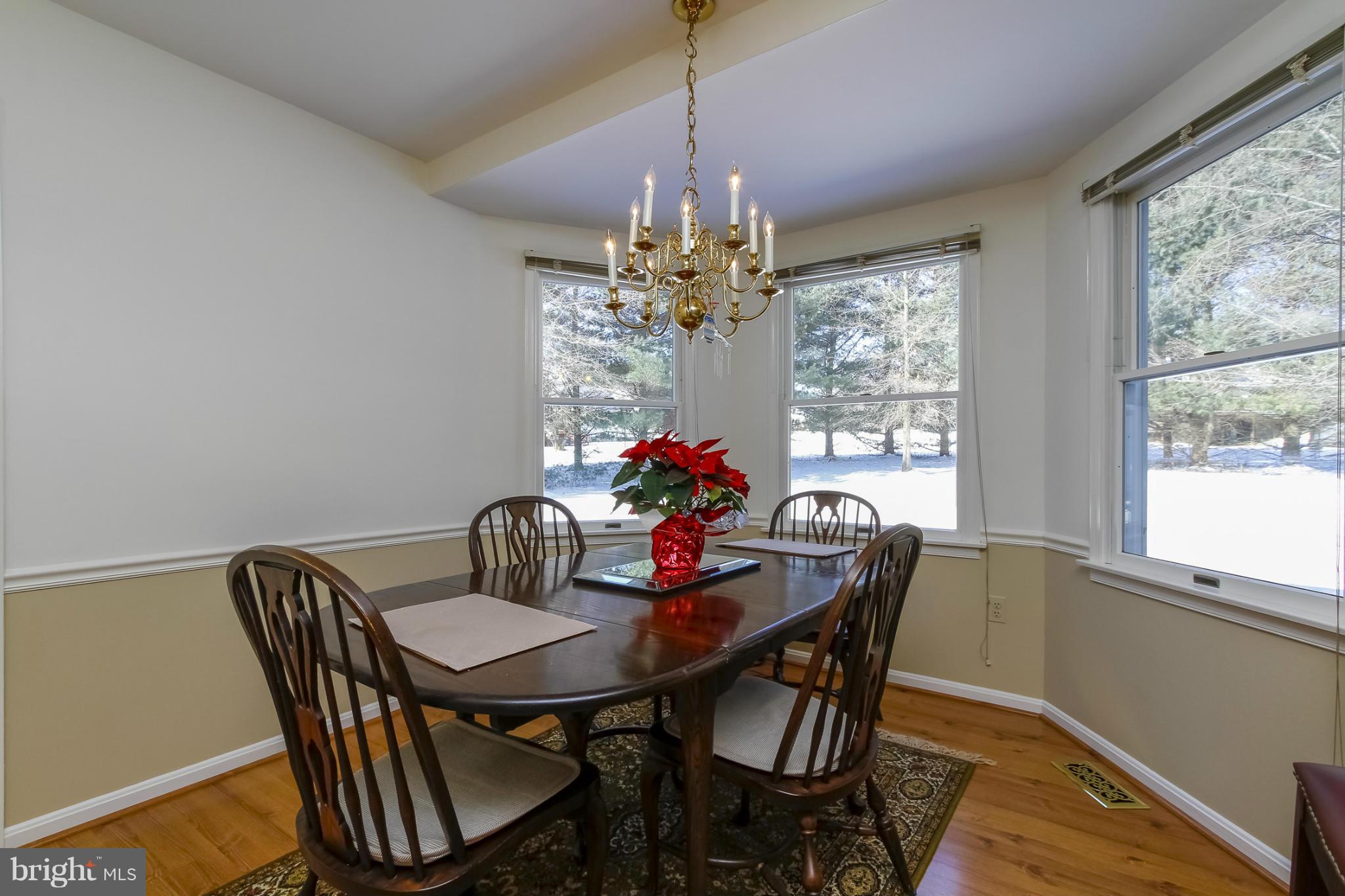 14015 Foxland Road Phoenix, MD 21131 - Photo 9 of 24 a dining room with furniture potted plants and wooden floor