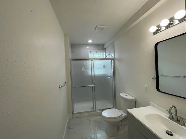 a bathroom with a toilet sink and a mirror