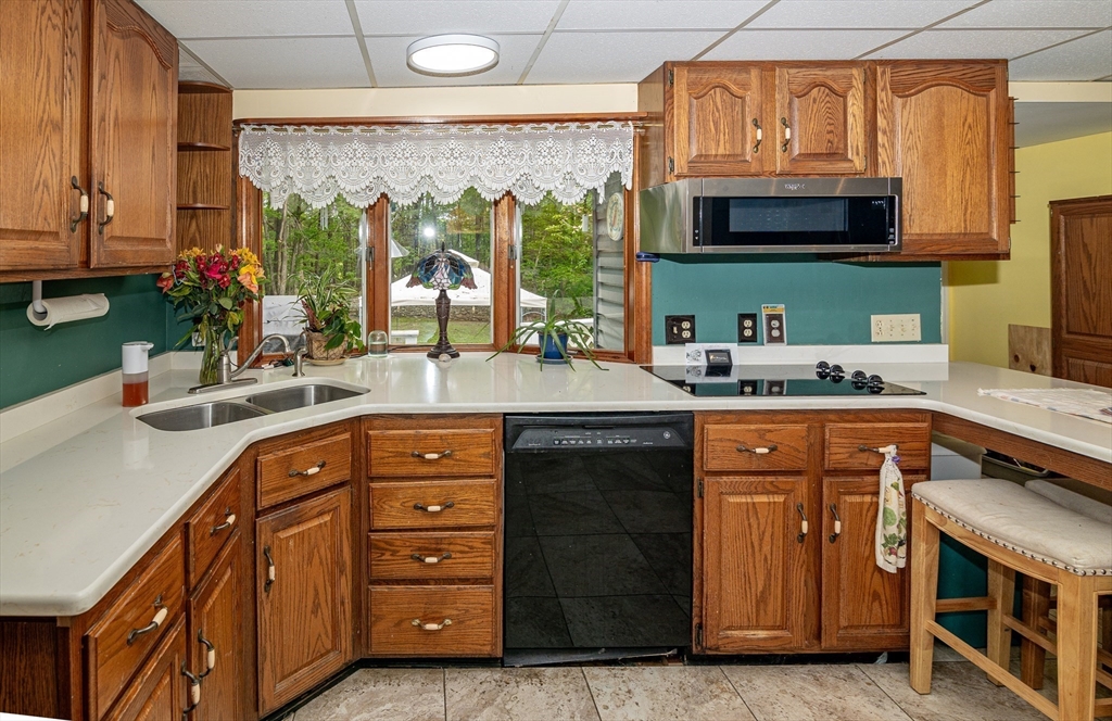 300 Mason Rd Extension Dudley, MA 01571 - Photo 12 of 42 a kitchen with stainless steel appliances wooden cabinets a stove and a sink