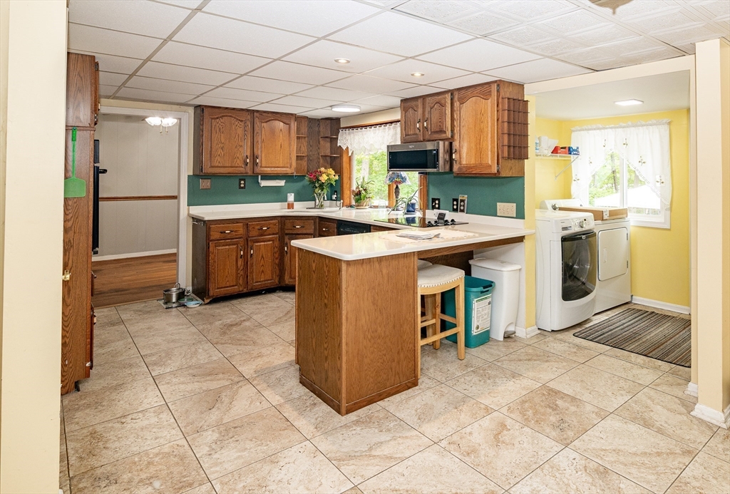 300 Mason Rd Extension Dudley, MA 01571 - Photo 16 of 42 a kitchen with kitchen island a stove a sink a refrigerator and a counter top space