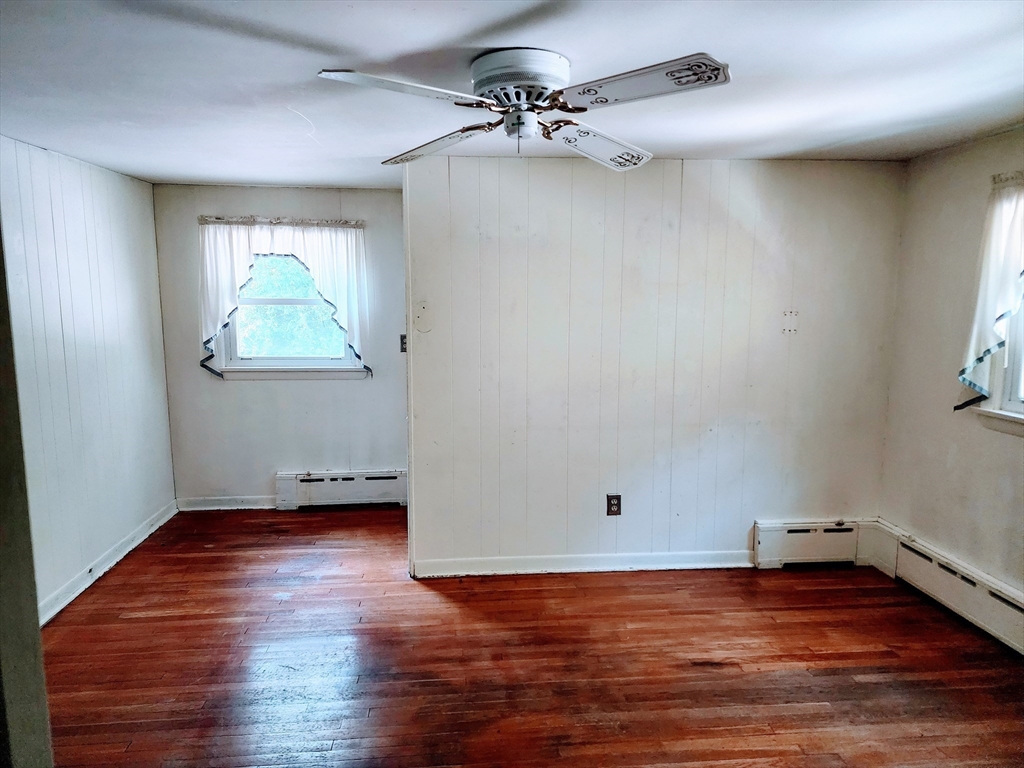 300 Mason Rd Extension Dudley, MA 01571 - Photo 17 of 42 an empty room with wooden floor and windows