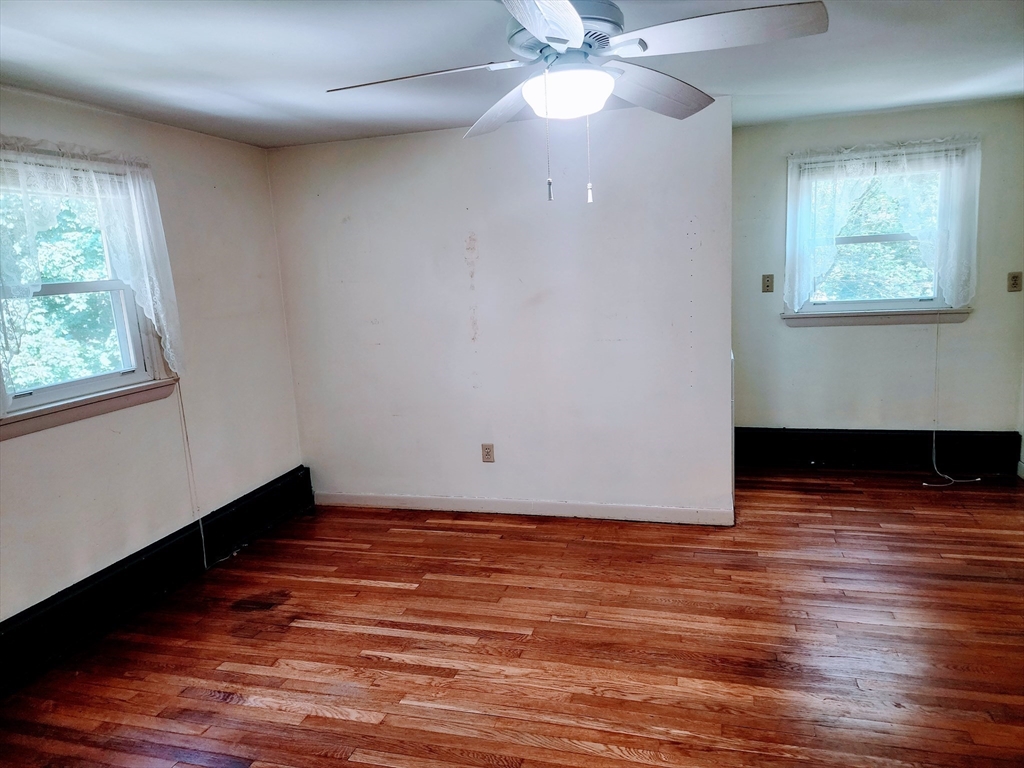 300 Mason Rd Extension Dudley, MA 01571 - Photo 38 of 42 an empty room with wooden floor and windows