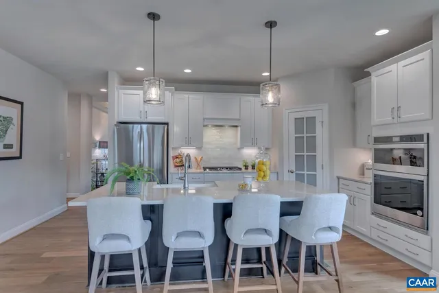 a view of a dining room with furniture a chandelier and wooden floor