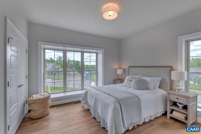 a bedroom with a bed and a large window