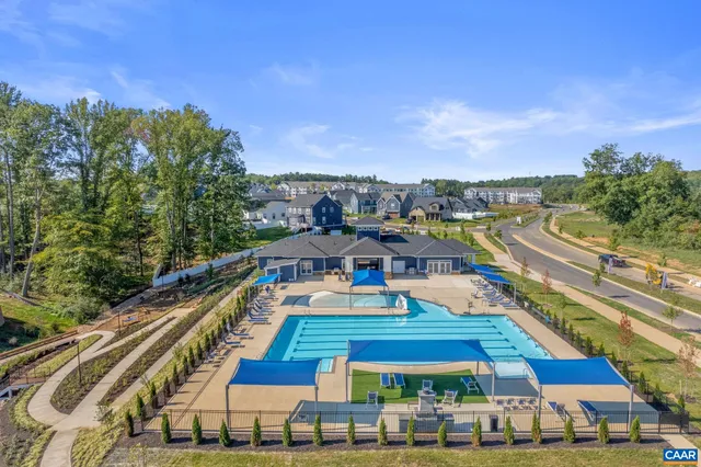 a view of a city with lots of car parked on the street side