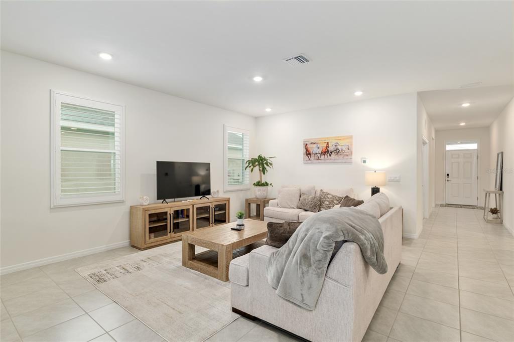5246 Northwest 43rd Ln Road Ocala, FL 34482 - Photo 11 of 84 a living room with furniture and a flat screen tv