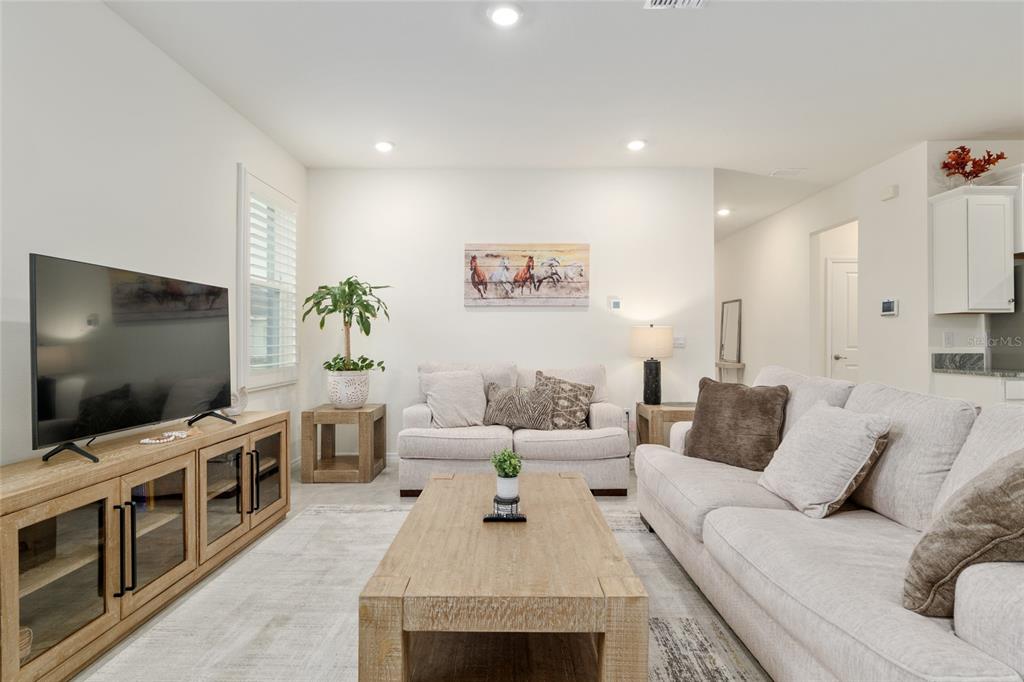 5246 Northwest 43rd Ln Road Ocala, FL 34482 - Photo 12 of 84 a living room with furniture and a flat screen tv
