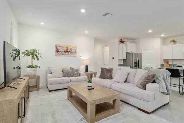 a kitchen with stainless steel appliances a stove top oven a refrigerator a sink and a stove