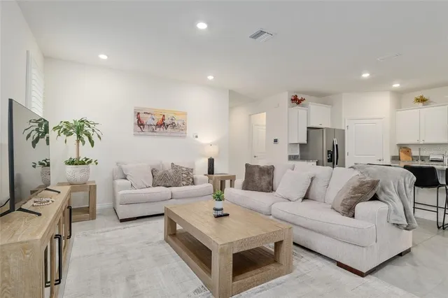 a kitchen with stainless steel appliances a stove top oven a refrigerator a sink and a stove