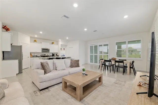 a kitchen with stainless steel appliances granite countertop a stove a sink a microwave and a refrigerator