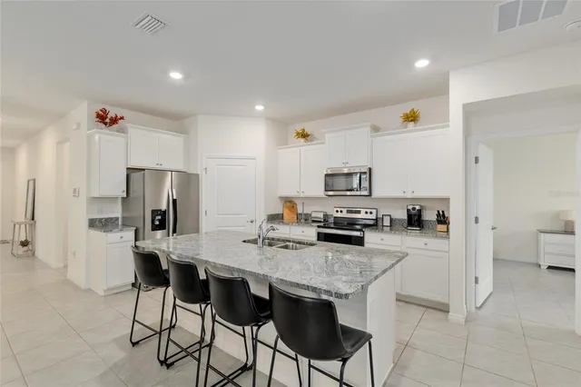 a kitchen with a sink stove and refrigerator