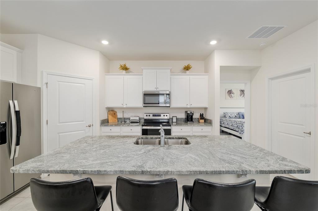 5246 Northwest 43rd Ln Road Ocala, FL 34482 - Photo 19 of 84 a kitchen with stainless steel appliances granite countertop a stove a sink a microwave and a refrigerator