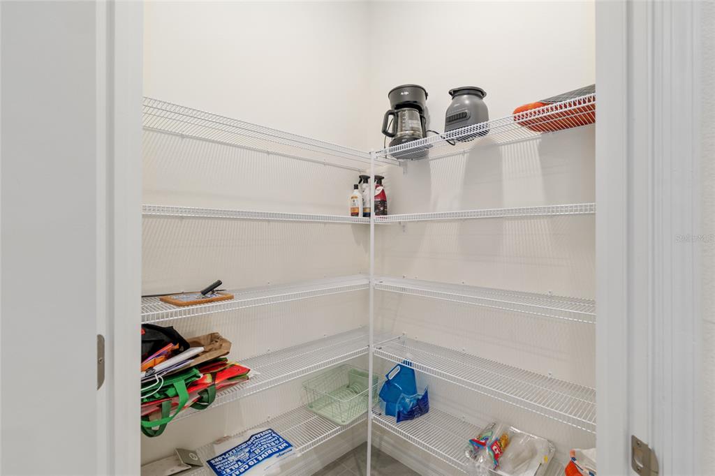 5246 Northwest 43rd Ln Road Ocala, FL 34482 - Photo 24 of 84 a view of storage and utility room with racks on the wall