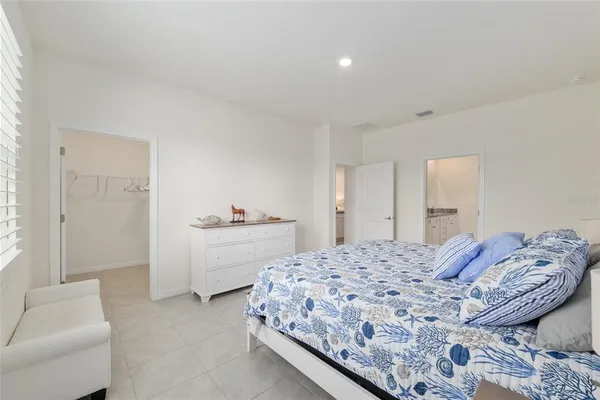 a porch with a table and chairs and couches with wooden floor