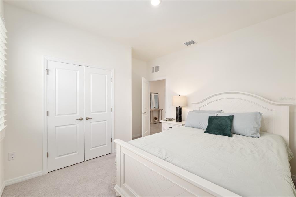 5246 Northwest 43rd Ln Road Ocala, FL 34482 - Photo 38 of 84 a bedroom with a bed and a night stand