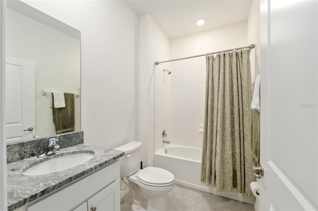 5246 Northwest 43rd Ln Road Ocala, FL 34482 - Photo 39 of 84 a bathroom with a granite countertop sink toilet and shower