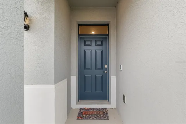 a living room with furniture a flat screen tv and a large window