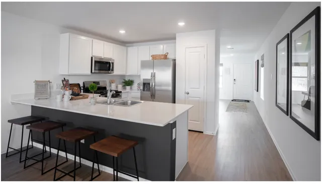 a kitchen with a table chairs and a refrigerator