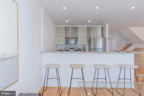 a kitchen with a sink and a wooden floor