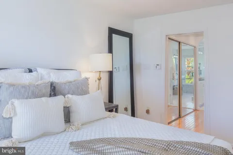 a spacious bathroom with a granite countertop sink a mirror and a shower