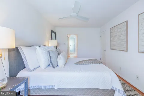 a bedroom with a bed and a potted plant