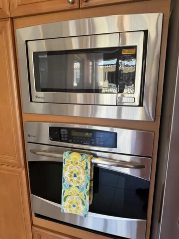 a stove top oven sitting inside of a kitchen