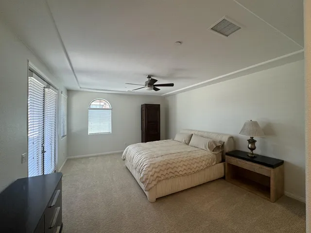 a bathroom with a granite countertop sink a mirror and a bathtub