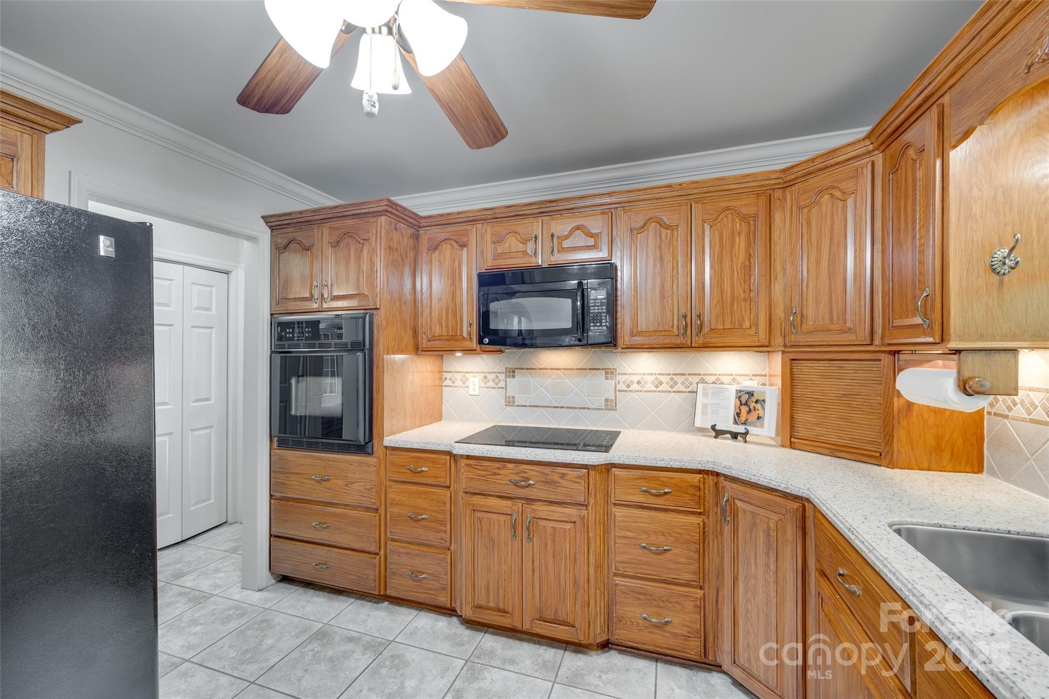 4307 Edgeland Road Edgemoor, SC 29712 - Photo 16 of 48 a kitchen with a sink window and cabinets