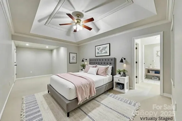 a bedroom with a large bed and a chandelier