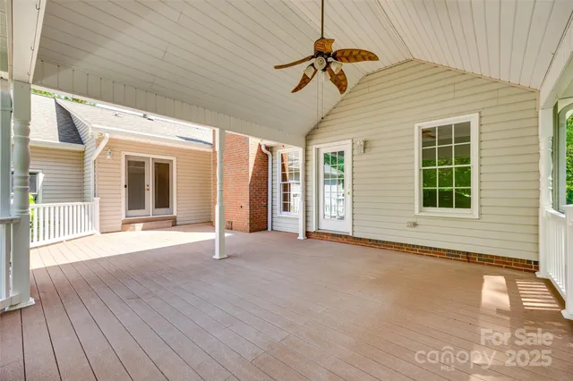 a view of a backyard with a deck and wooden floor
