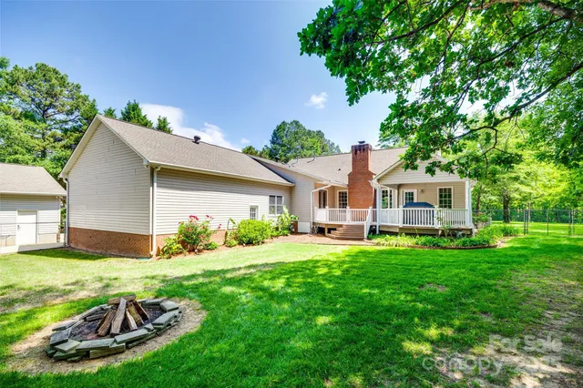 a view of backyard of house with green space