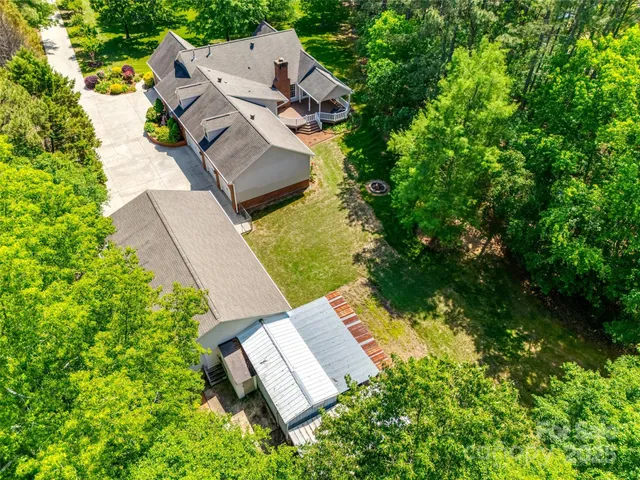 an aerial view of a house with garden space and street view
