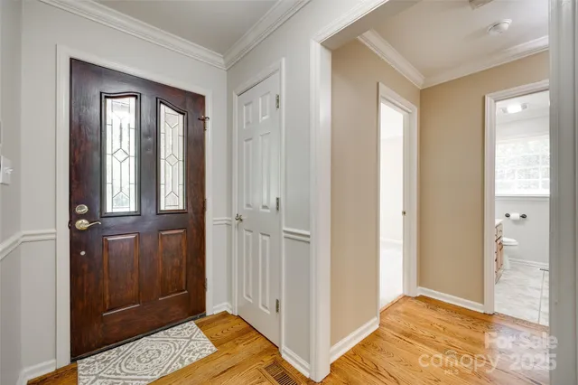 a view of bedroom with window and hallway