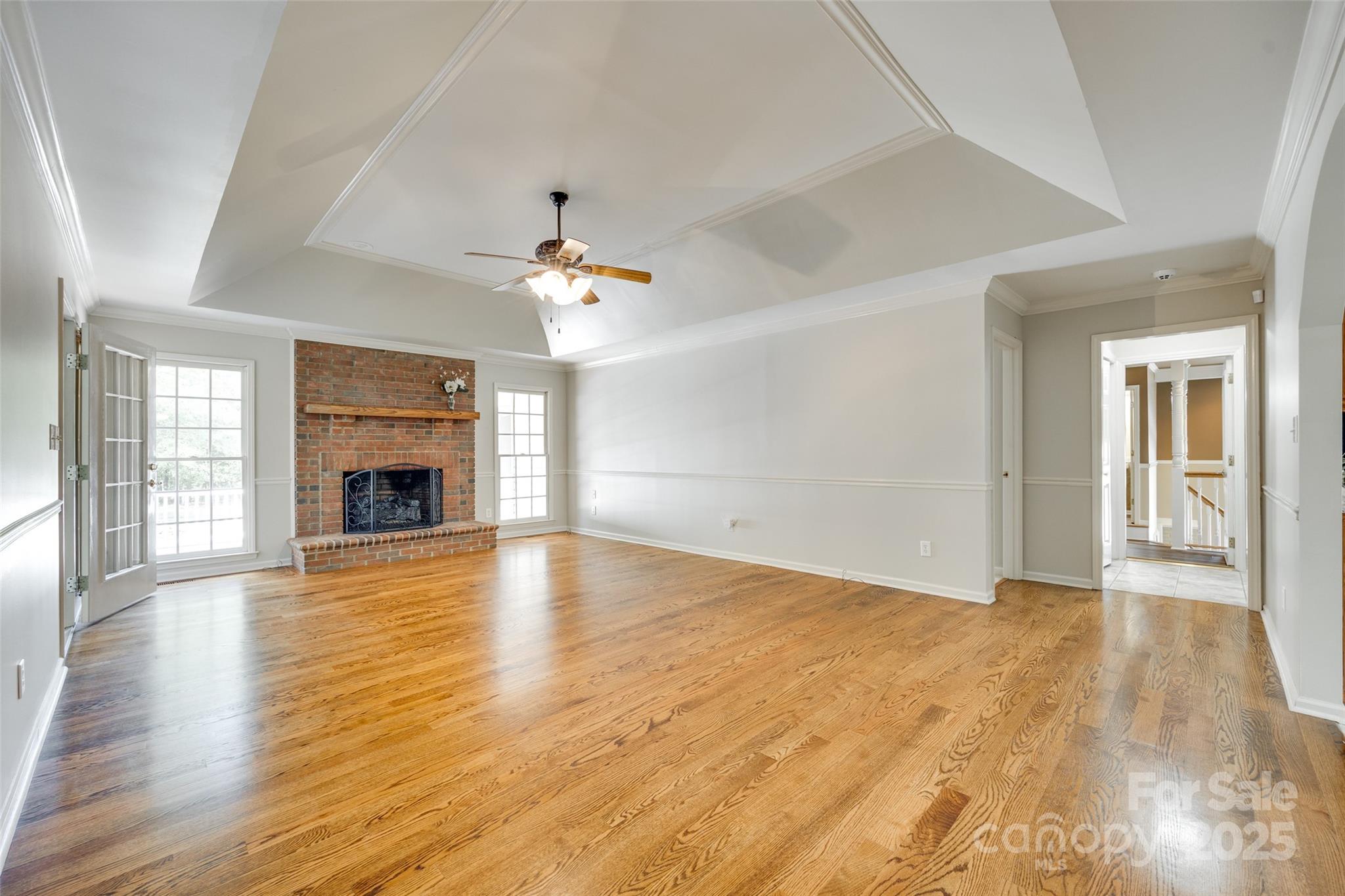 4307 Edgeland Road Edgemoor, SC 29712 - Photo 10 of 48 an empty room with wooden floor and fireplace