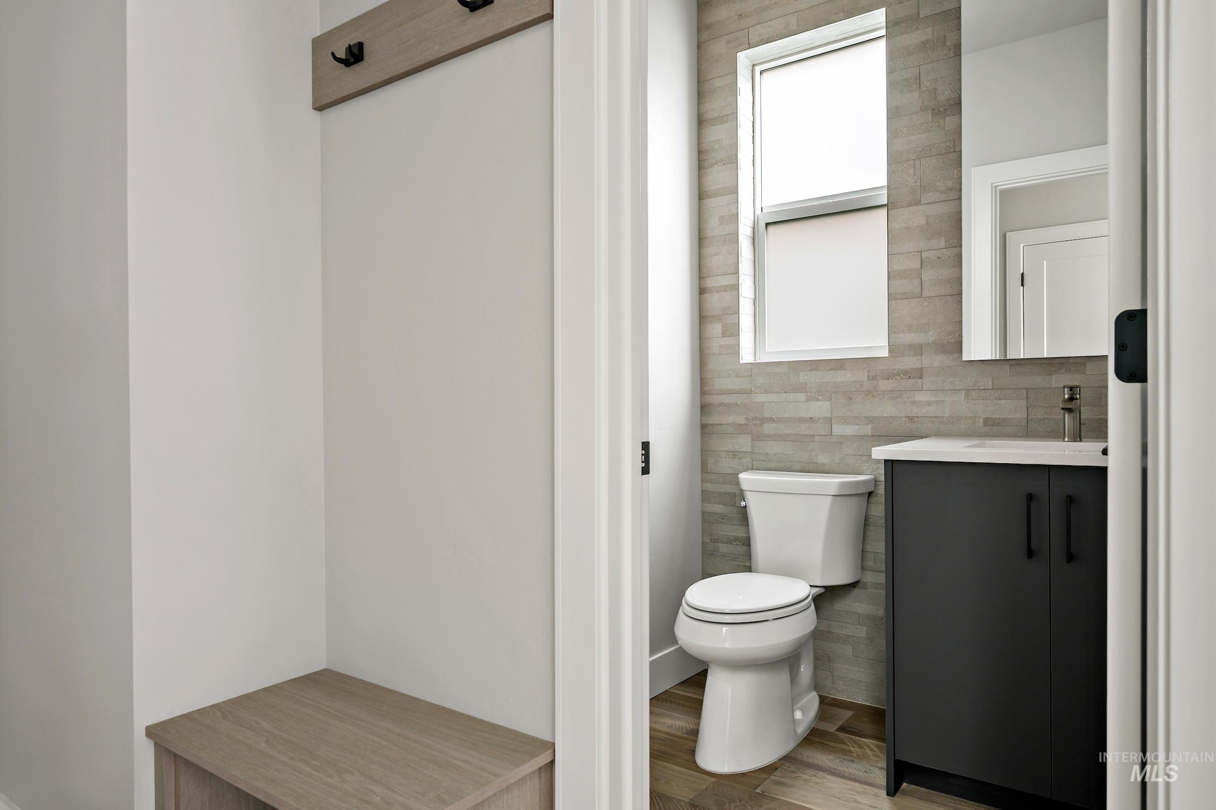 11709 North Rabbitbrush Way Boise, ID 83714 - Photo 19 of 31 Bathroom featuring vanity, light wood finished floors, and tile walls