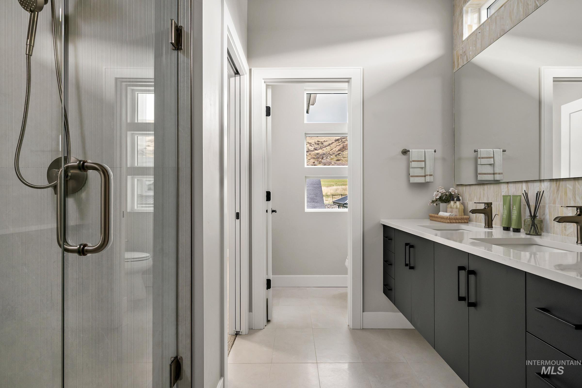 11709 North Rabbitbrush Way Boise, ID 83714 - Photo 24 of 31 Full bath featuring double vanity, healthy amount of natural light, a shower stall, and light tile patterned floors