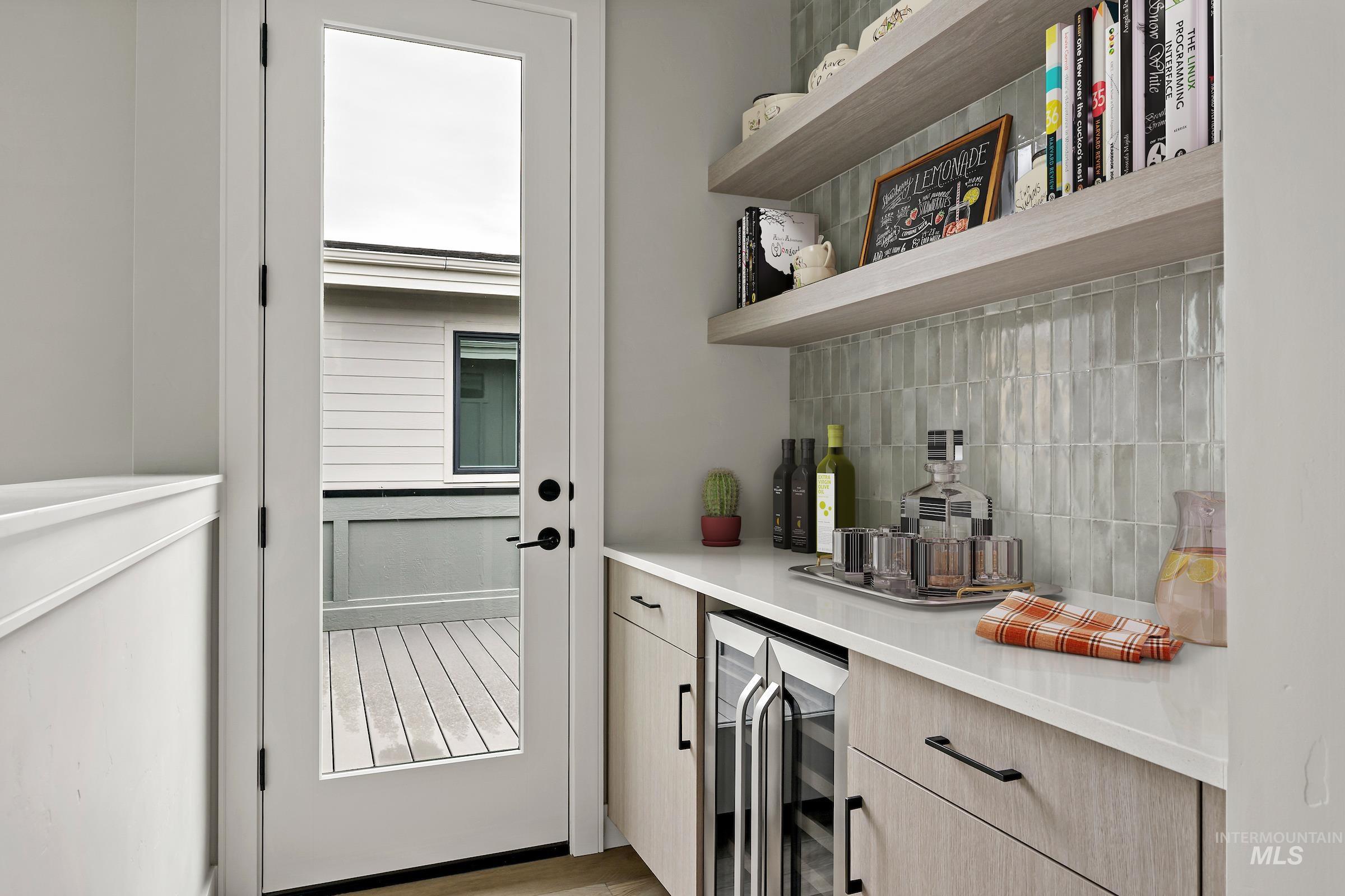 11709 North Rabbitbrush Way Boise, ID 83714 - Photo 26 of 31 Bar area featuring decorative backsplash, wine cooler, light countertops, and light brown cabinets