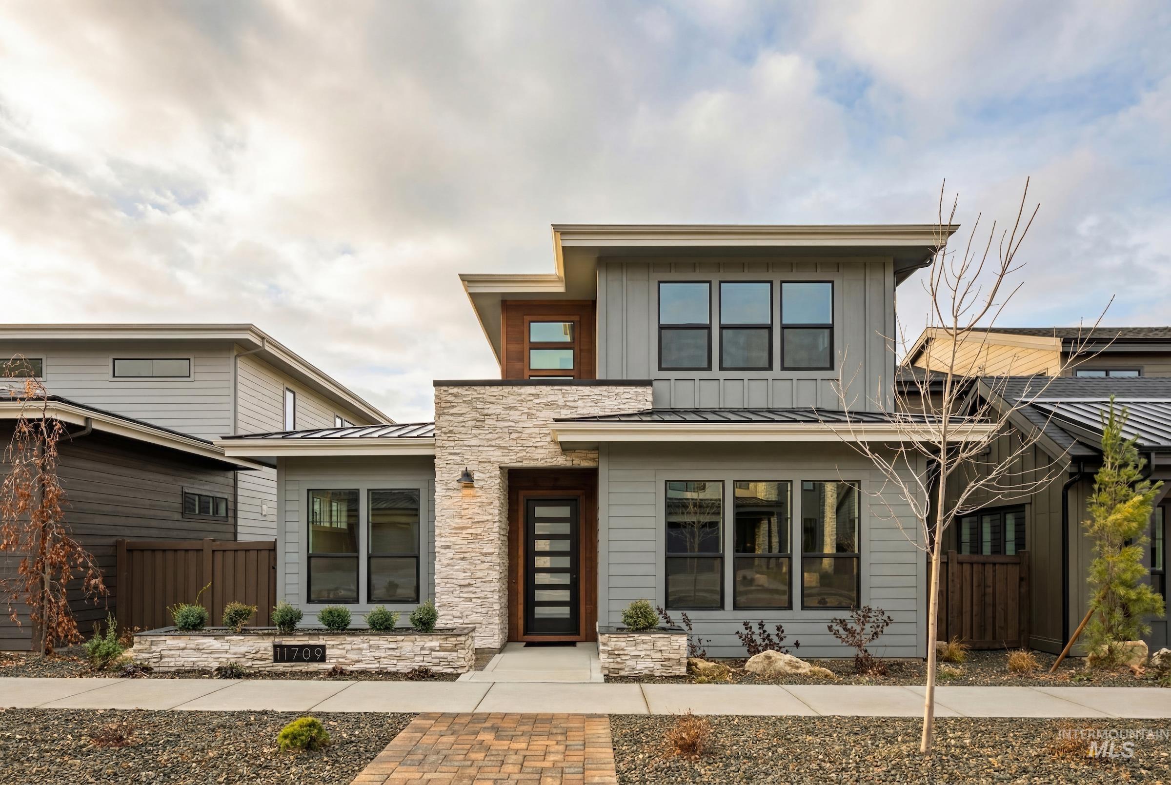11709 North Rabbitbrush Way Boise, ID 83714 - Photo 30 of 31 Modern home featuring a standing seam roof, a metal roof, and stone siding