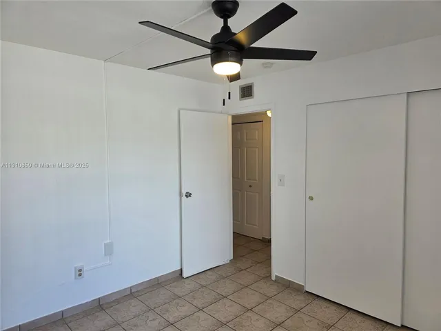 a couple of cars parked in front of a house