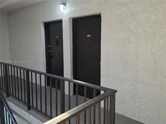 a view of staircase with railing and a window
