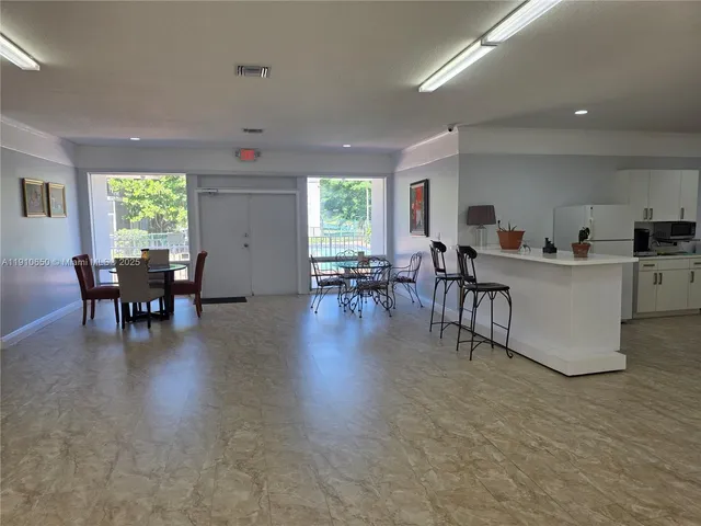 a view of a backyard with a large tree and a yard