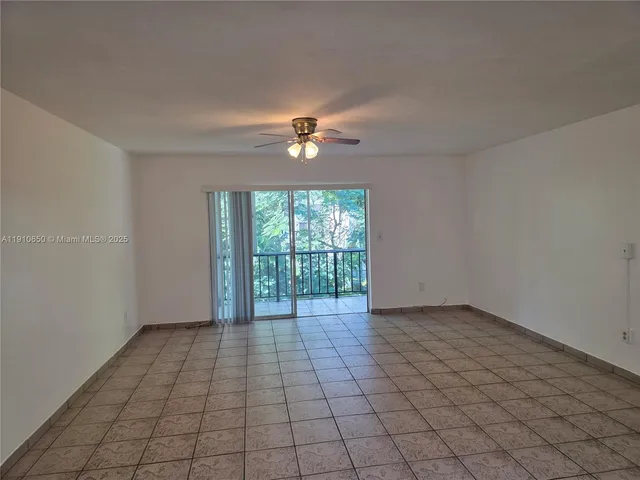 a view of kitchen with refrigerator and cabinets
