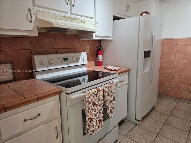 a kitchen with cabinets and window