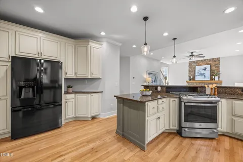 a kitchen with stainless steel appliances granite countertop wooden cabinets and sink